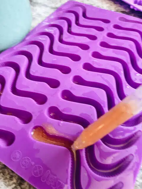 gummy worm mold being filled